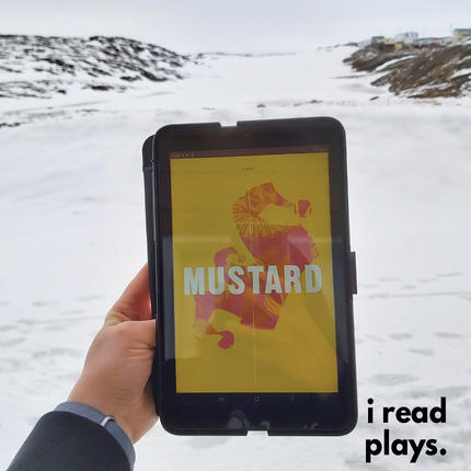 A hand holds a tablet showing the cover of Mustard in front of a snowy background.