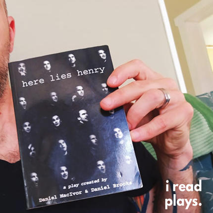 Richie Wilcox holds up a copy of Here Lies Henry