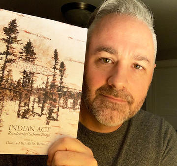 Keith Barker holds a copy of Indian Act